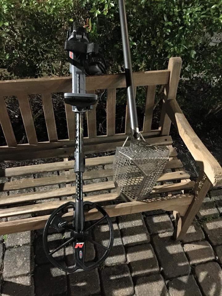 A metal pole sitting on top of a wooden bench.